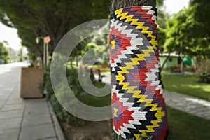 Tree wrapped in colorful rope