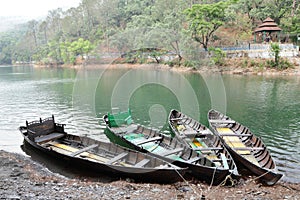 Trees and boat on the bank of Sattal lake