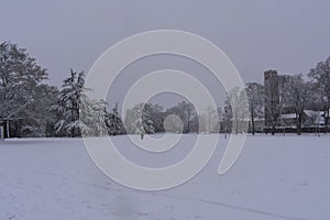 Trees and buildings covered by fresh white snow in center Leamington Spa, Pump Room Gardens, UK - winter landscape, december 2017