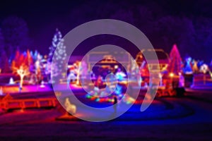 Trees and houses in christmas lights blurred view