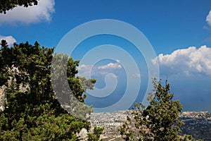 Trees and panoramic views from the castle of Saint Hilarion to the city of Kyrenia, the sky and the Mediterranean sea.