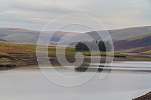 Trees reflected in the Craig Goch Reservoir, on edge of Mid-Wales wilderness. photo