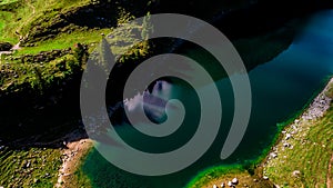 Trees with shadow on deep blue mountain lake aerial view switzerland