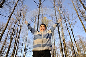 Trees view upwards and happy boy