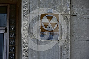 Fallout shelter capacity sign on the side of a bank photo