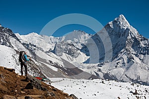 Trekker approaching Amadablam mount in Khumbu valley on a way to