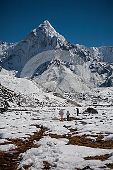 Trekker approaching Amadablam mount in Khumbu valley on a way to photo