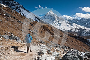 Trekker approaching Amadablan mount in Khumbu valley on a way to