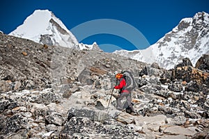 Trekker approaching PumoRi mountain in Khumbu valley on a way to