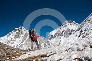 Trekker approaching PumoRi mountain in Khumbu valley on a way to