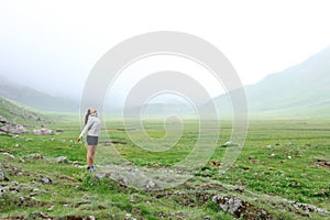 Trekker breathing fresh air in the mountain a foggy day