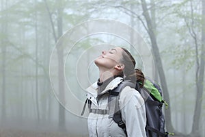 Trekker breathing fresh air in nature a foggy day