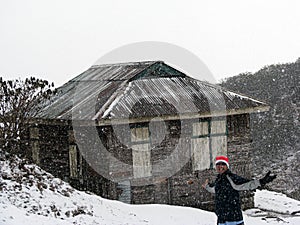 Trekker celebrating and loving the snowfall in mountain, Sikkim, India. Work life balance concept