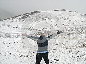 Trekker celebrating and loving the snowfall in mountain, Sikkim, India. Work life balance concept