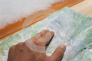 A trekker checking a map during his trip