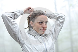 Trekker doing ponytail in a forest