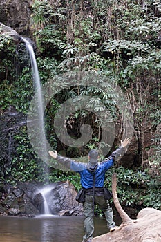 Trekker found waterfall in forest park green fresh air.