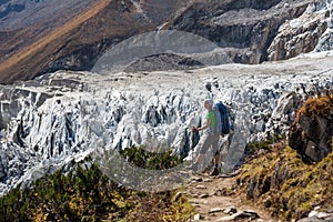 Trekker in front of Manaslu glacier on Manaslu circuit trek in N