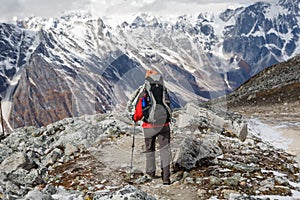 Trekker goes down fron Larke La pass on Manaslu circuit trek in