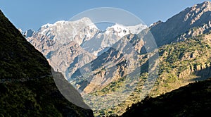 A trekker on Manaslu circuit with viiew of snow covered Mount Manaslu 8 156 meters. Himalayas, sunnyat Manaslu, Gorkha, Nepal