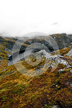 Trekker on Munken Mountain trail, Lofoten Islands, Norway