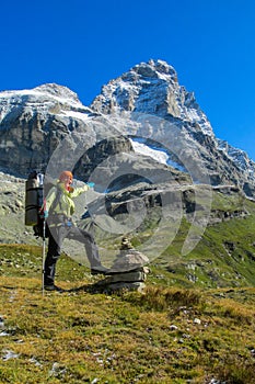 Trekker near Matterhorn summit wall from Italy, Monte Cervino