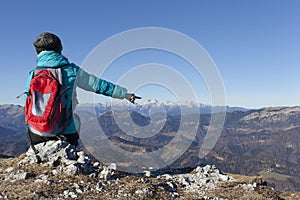 Trekker pointing on Mount Triglav