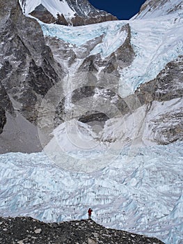 Trekker Standing in Front of Khumbu Glacier in Nepal photo