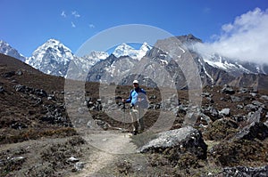 Trekker is standing on the trail to Ama Dablam base camp, Nepal