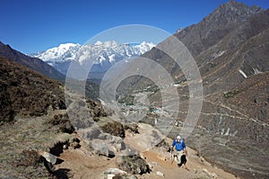 Trekker on the trail to Ama Dablam base camp, Nepal