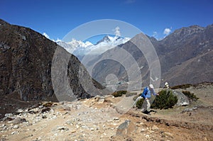 Trekker on the trail to Ama Dablam base camp, Nepal