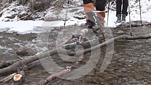 Trekker traveller overcomes a water barrier.