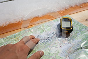 A trekker using a gps during his trip in the mountain
