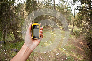 A trekker using a gps inside the forest