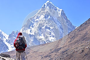 Trekker walking at high mountain.