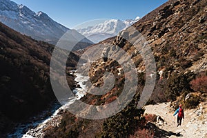 A trekker walking on trail to Everest base camp in Himalaya mountains range, Nepal