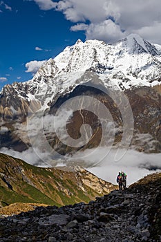 Trekker on the way to the valley covered with cloud on Manaslu c