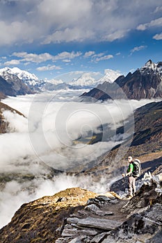 Trekker on the way to the valley covered with cloud on Manaslu c