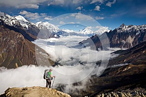 Trekker on the way to the valley covered with cloud on Manaslu c