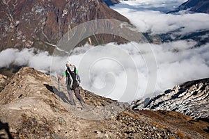 Trekker on the way to the valley covered with cloud on Manaslu c