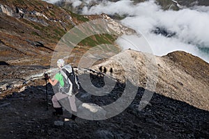 Trekker on the way to the valley covered with cloud on Manaslu c