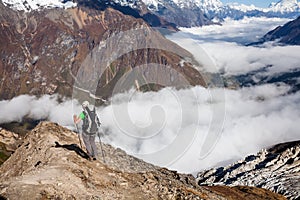 Trekker on the way to the valley covered with cloud on Manaslu c