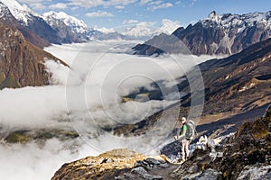 Trekker on the way to the valley covered with cloud on Manaslu c