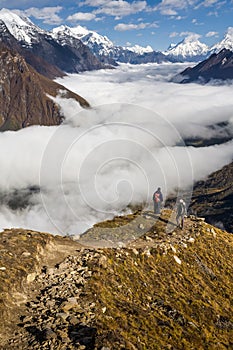 Trekker on the way to the valley covered with cloud on Manaslu c