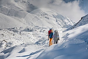 Trekkers crossing Gokyo glacier in Khumbu valley on a way to Eve