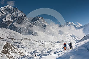 Trekkers crossing Gokyo glacier in Khumbu valley on a way to Eve