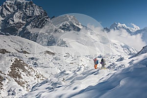 Trekkers crossing Gokyo glacier in Khumbu valley on a way to Eve