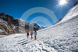 Trekkers crossing Gokyo glacier in Khumbu valley on a way to Eve