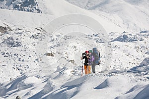 Trekkers crossing Gokyo glacier in Khumbu valley on a way to Eve