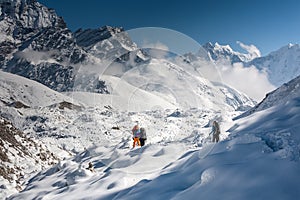 Trekkers crossing Gokyo glacier in Khumbu valley on a way to Eve